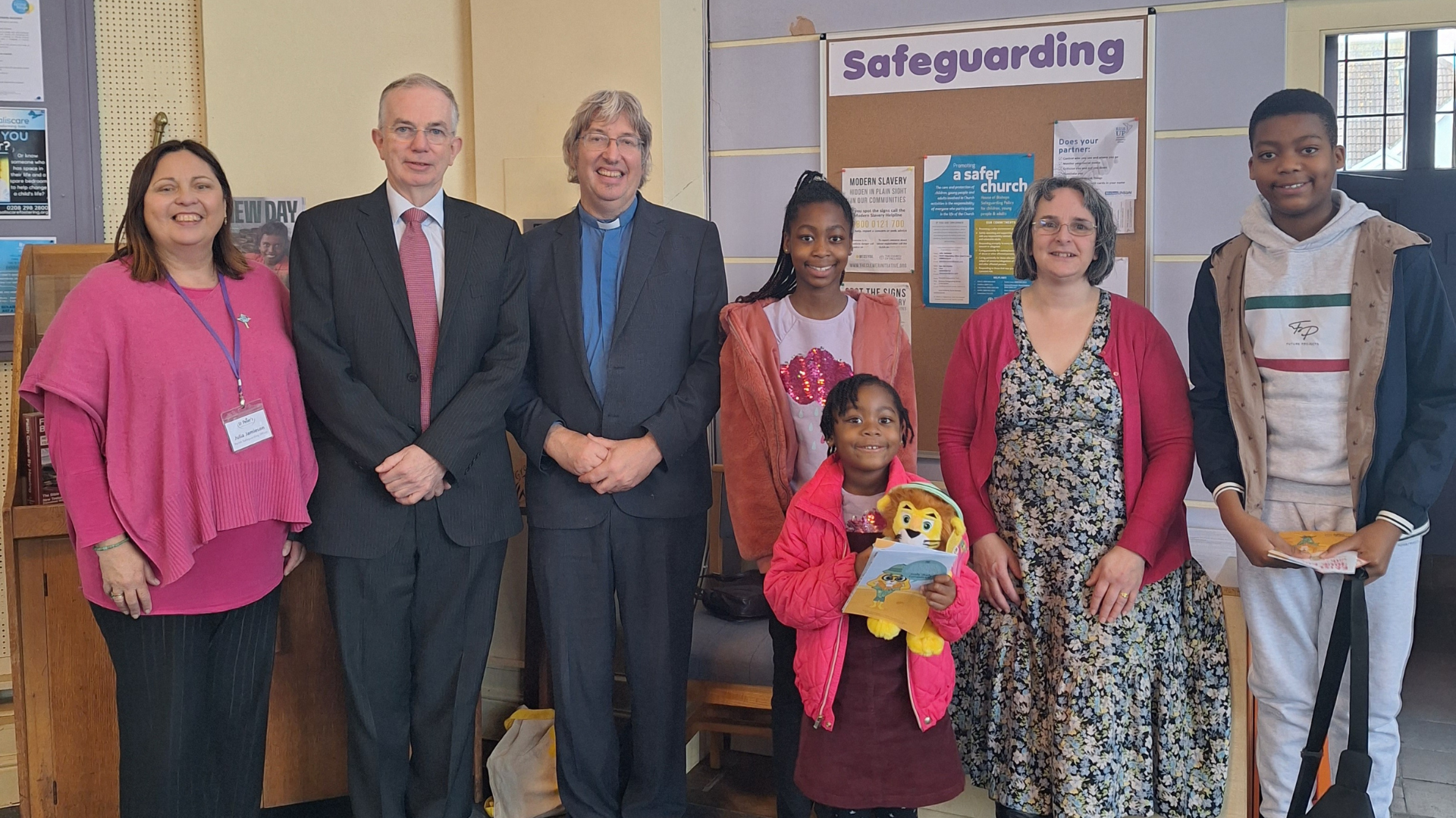group shot including a child holding a Roarry lion toy 