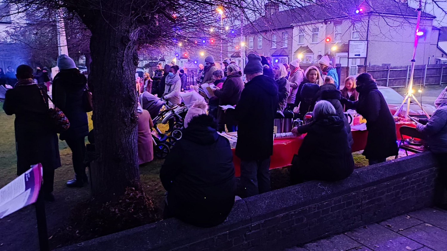 People gather outside for carols in Slade Green