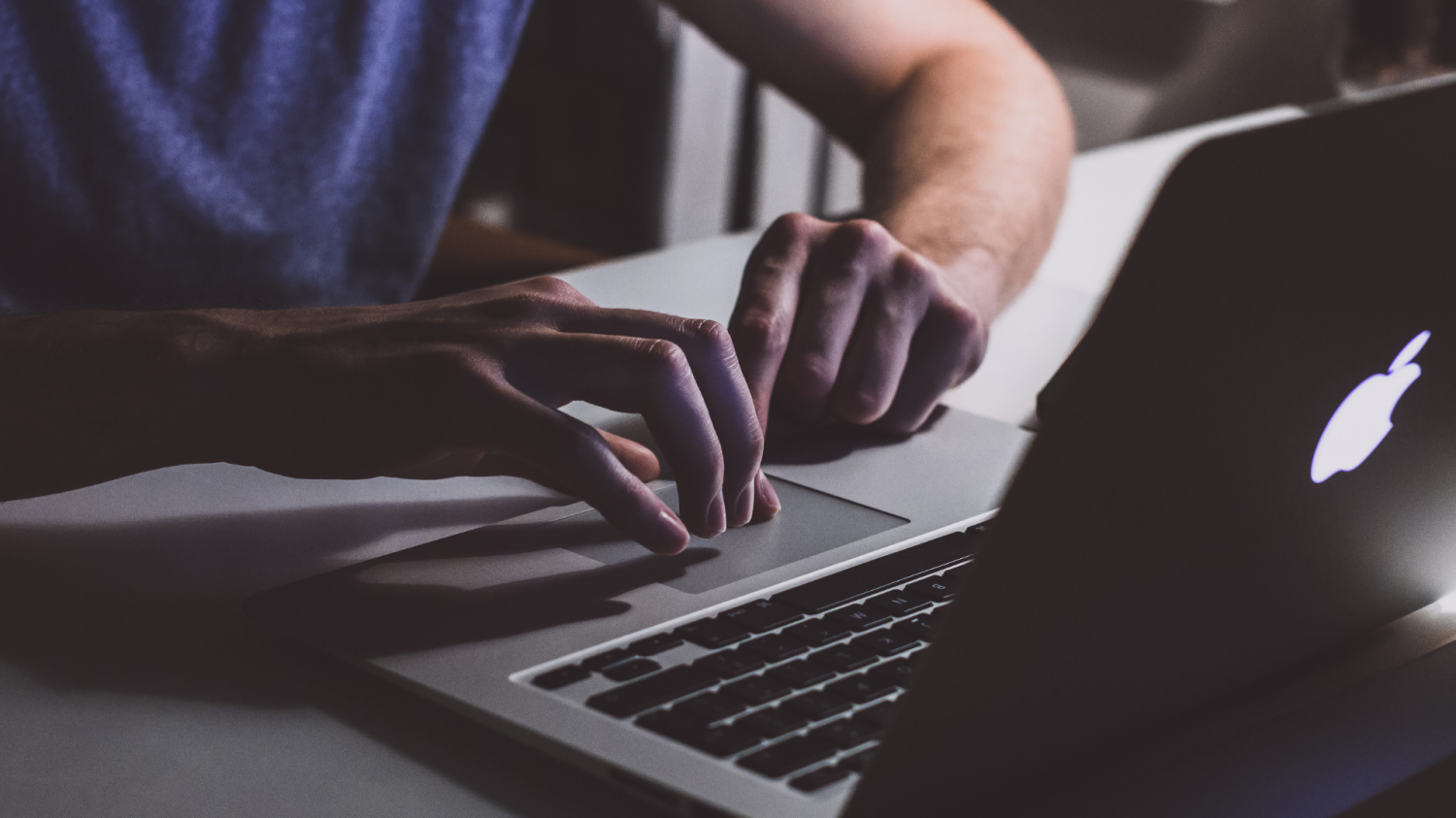 A person types on a laptop keyboard