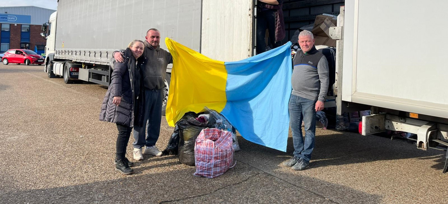 Donators hold up a Ukraine flag