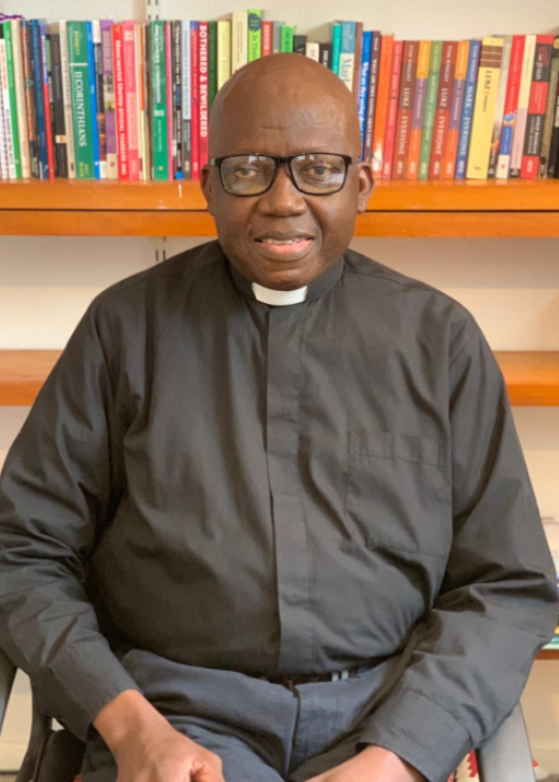 The Rev Cyril Showers smiles towards the camera in his office