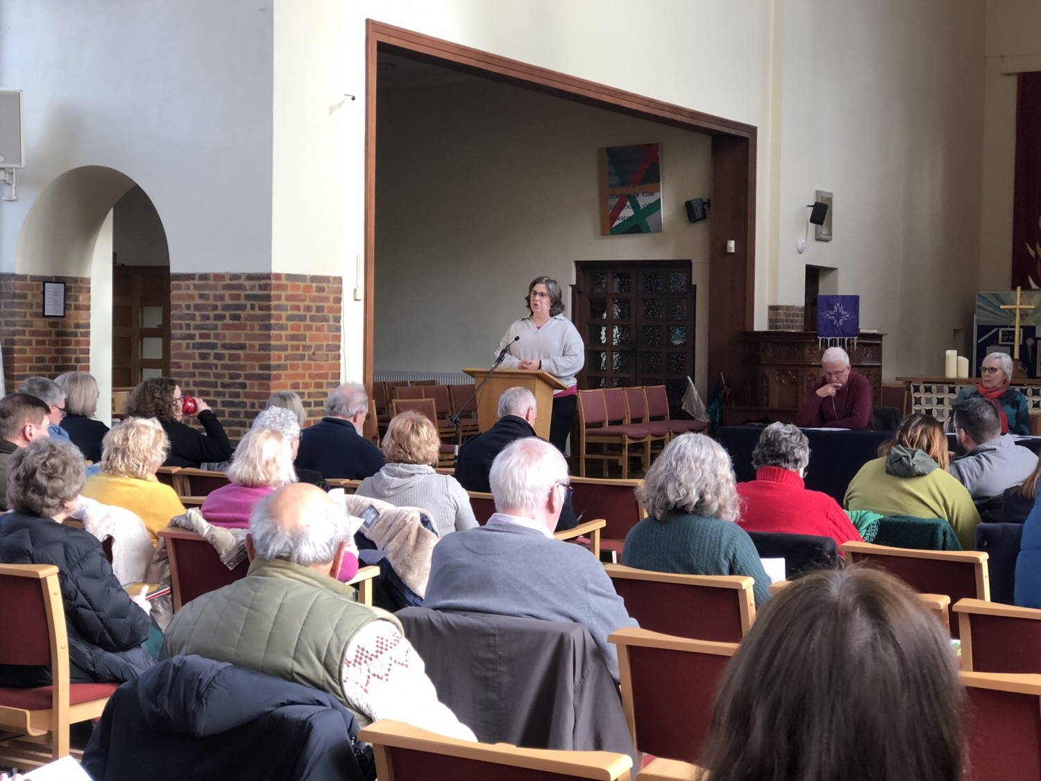 Claire Boxall stands at the lectern and addresses Synod